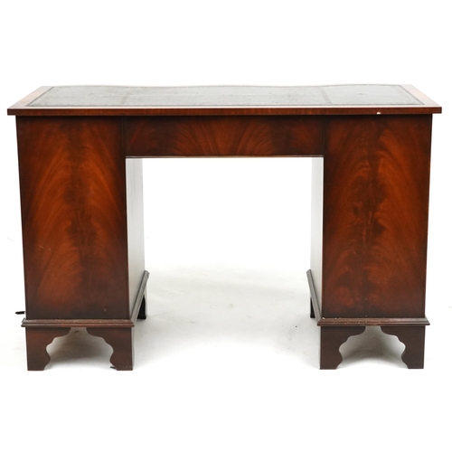 2025 - A late 20th century mahogany serpentine fronted twin pedestal desk fitted with an arrangement of nin... 