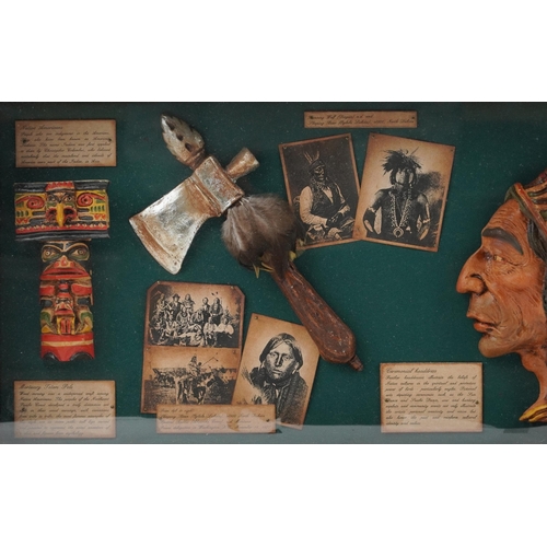 1077 - A 20th century stained pine display case enclosing reproduction Native American items alongside desc... 