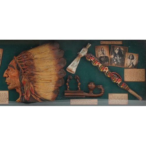 1077 - A 20th century stained pine display case enclosing reproduction Native American items alongside desc... 