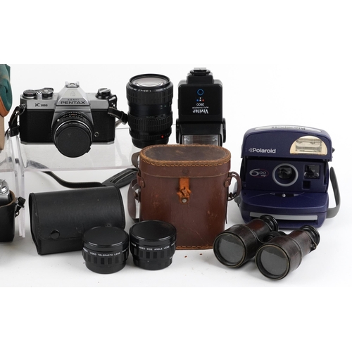 1008 - A group of various cameras and binoculars including a Pentax K1000, a Polaroid 600AF, a Zenit-E, a p... 