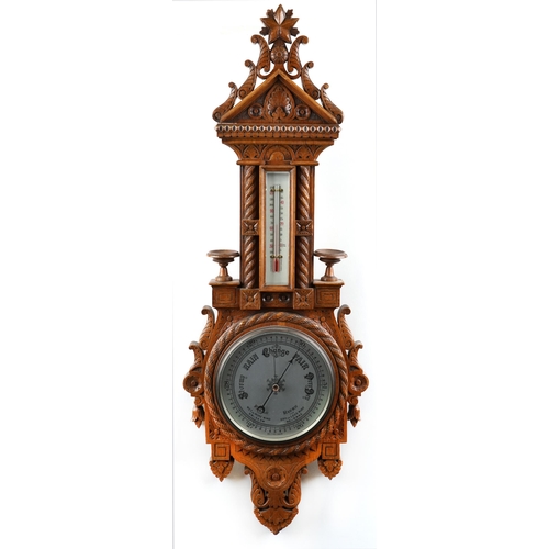 2168 - A late Victorian carved oak wall hanging barometer, 95cm in length.