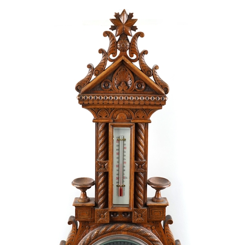 2168 - A late Victorian carved oak wall hanging barometer, 95cm in length.