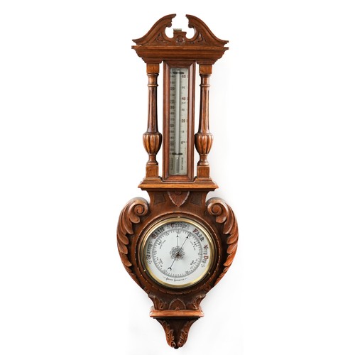 2170 - A late Victorian carved oak wall hanging aneroid barometer, 99cm in length.