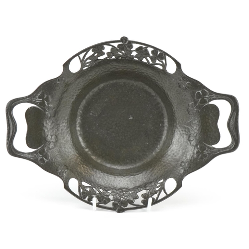 11 - A Tudric pewter Art Nouveau bowl circa 1900, with overall hammered finish, piereced swirling handles... 