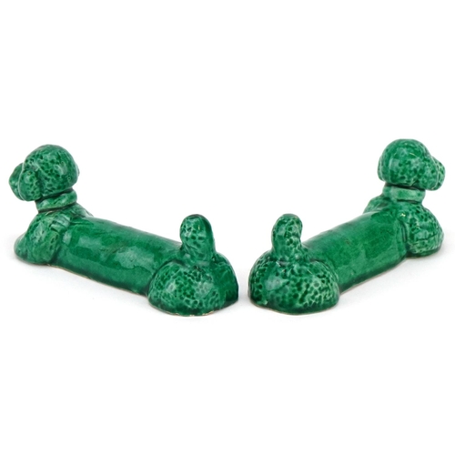 364 - A pair of 'poodle' knife rests, circa 1950, each green glazed elongated hound stamped Denys Chiapell... 