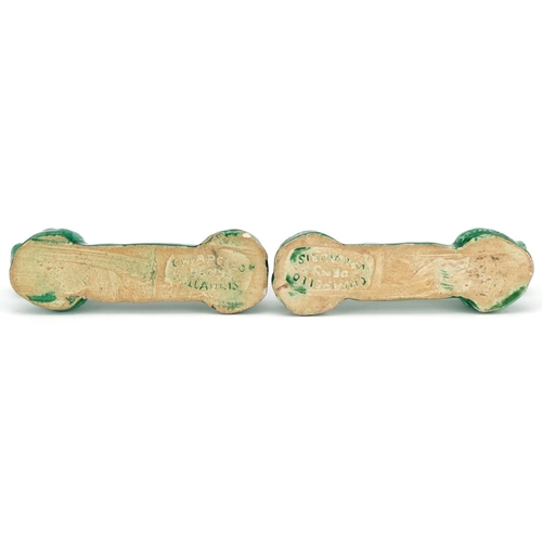 364 - A pair of 'poodle' knife rests, circa 1950, each green glazed elongated hound stamped Denys Chiapell... 