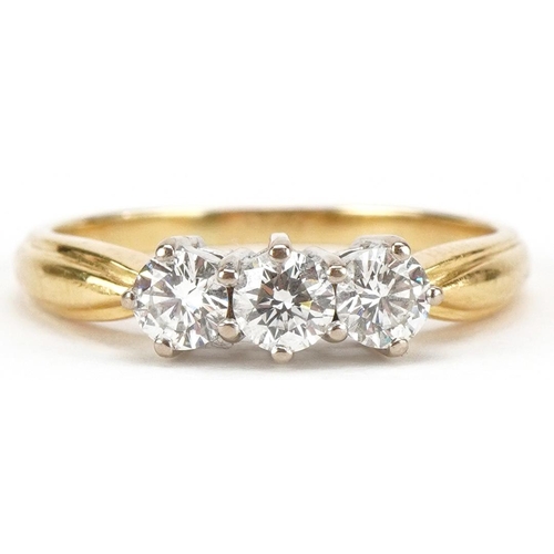 3002 - An 18ct gold diamond trilogy ring, total diamond weight approximately 0.75 carat, size T/U, 3.8g.