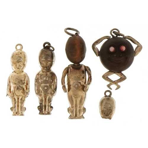 2438 - Three British military Fumsup good luck charms and a Touch Wood charm, the largest 3cm high.