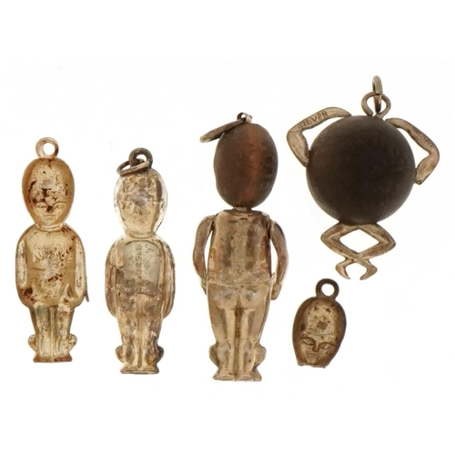 2438 - Three British military Fumsup good luck charms and a Touch Wood charm, the largest 3cm high.