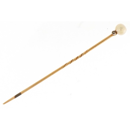 3382 - An unmarked gold cultured pearl and diamond stickpin, 6.6cm in length, 1.3g, housed in a Gass & Co L... 