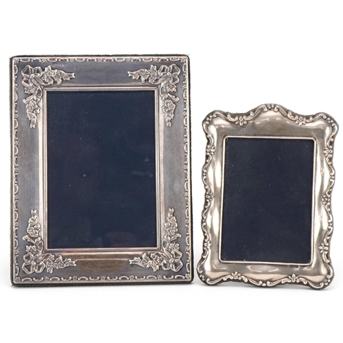 519 - Two rectangular embossed silver easel photo frames, the largest 18cm high.