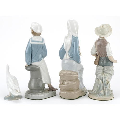 466 - Three Lladro figurines and a Lladro goose including a boy with a toy yacht, the largest 22.5cm high.