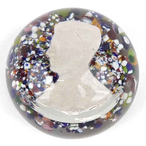 487 - An unusual 20th century glass paperweight inset with a head and shoulders profile bust, possibly of ... 