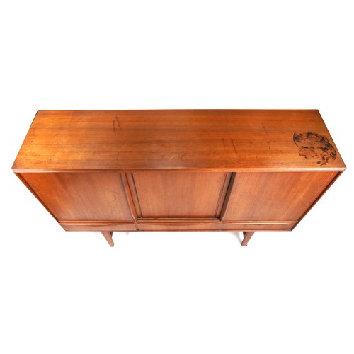 2010 - A mid 20th century teak sideboard fitted with sliding doors above three drawers, on tapering legs, 1... 