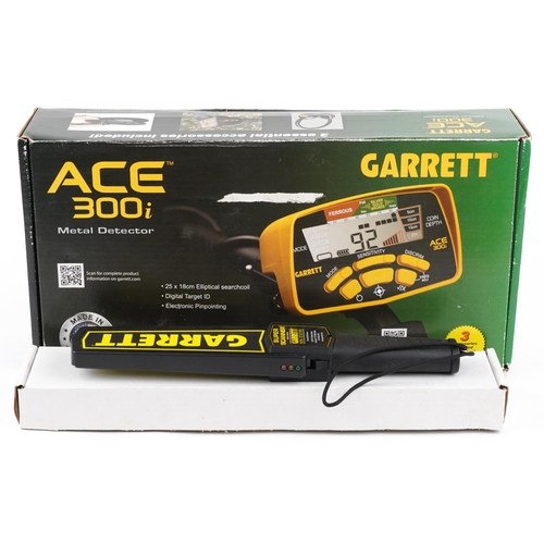 1074 - A Garrett Ace 300i metal detector including ear defenders, boxed together with a Garrett Super Scann... 