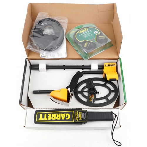 1074 - A Garrett Ace 300i metal detector including ear defenders, boxed together with a Garrett Super Scann... 