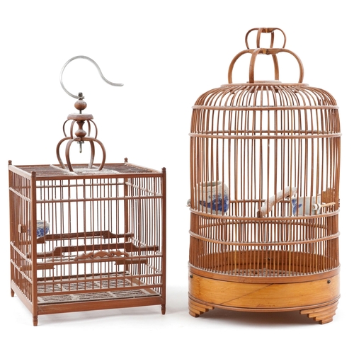 1086 - Two Chinese softwood decorative bird-cages, 20th century, one cylindrical, the other of square form,... 