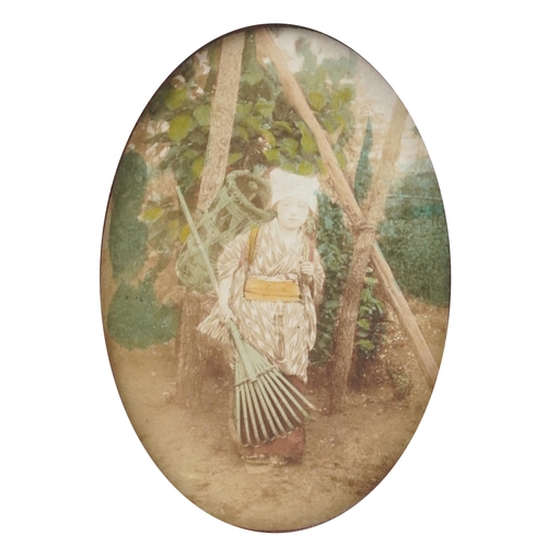 212 - An early 20th century hand coloured photograph of a Chinese girl collecting fruit within an Arts & C... 