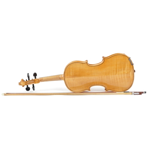 1042 - A child's wooden violin and bow housed in a fitted protective case, the violin back 13.5 inches in l... 