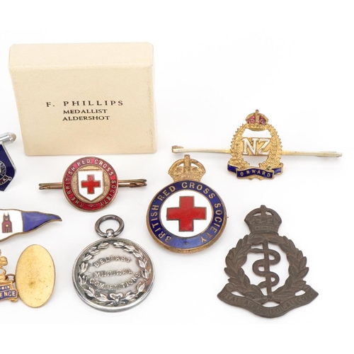 1096 - A group of military interest enamelled badges and medallions including British Red Cross Society, Na... 