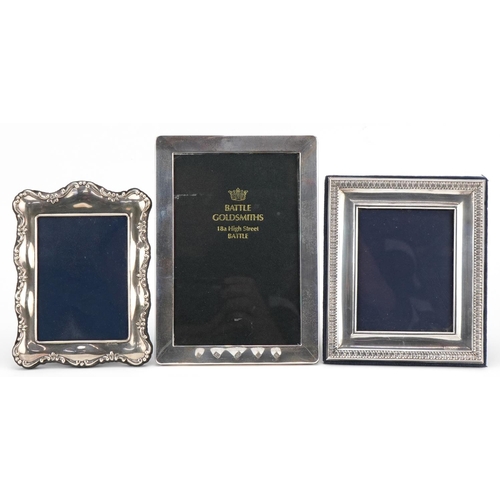 582 - Three rectangular silver easel photo frames, the largest 18cm high.