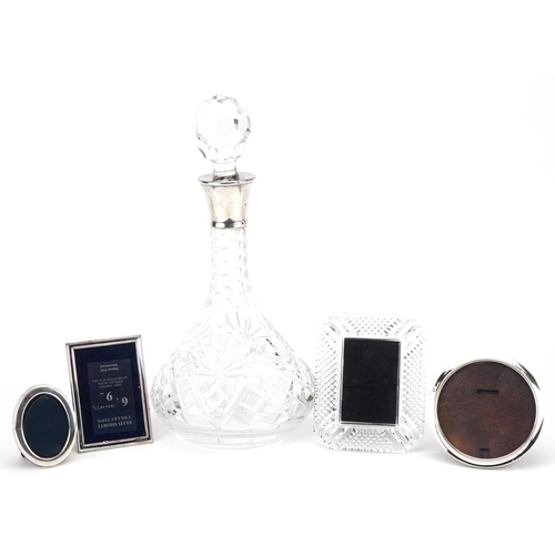 590 - Three miniature silver easel photo frames, a cut glass decanter with silver collar and a Waterford C... 