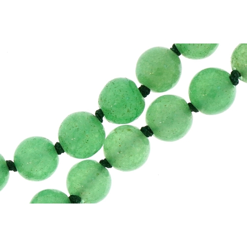 3668 - A Chinese green jade bead necklace, each bead 8.2mm in diameter, 70cm in length, 58.6g.