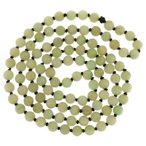 3130 - A Chinese pale green jade bead necklace, each bead 10.2mm in diameter, 120cm in length, 149.0g.