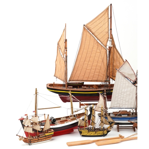 1066 - A collection of various 20th century scratch built model yachts, variously sized, each with sails an... 