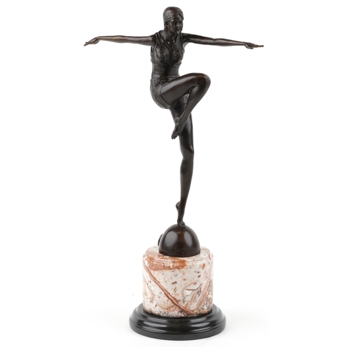 338 - A patinated bronze study of an Art Deco female dancer raised on a marble column base, 55cm high.