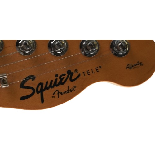 1038 - A Squire Telecaster six string electric guitar with natural wood finish and black scratch plate with... 