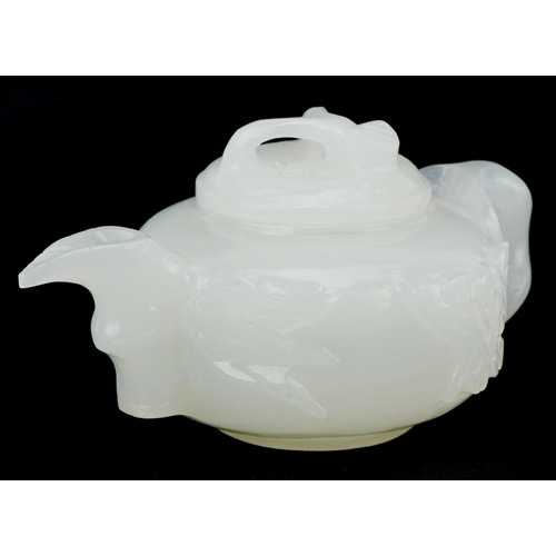 208 - A Chinese white jade teapot and cover, 20th century, with carved naturalistic decoration, 18cm wide.