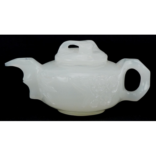 208 - A Chinese white jade teapot and cover, 20th century, with carved naturalistic decoration, 18cm wide.