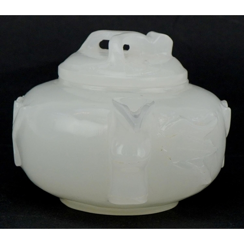 208 - A Chinese white jade teapot and cover, 20th century, with carved naturalistic decoration, 18cm wide.