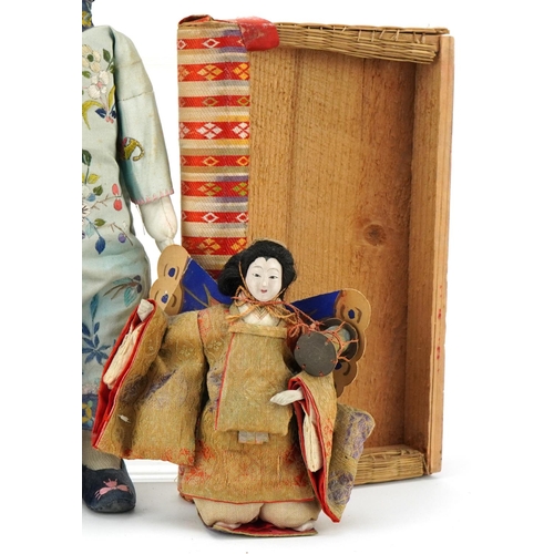 1094 - A group of three Chinese dolls, 20th century, various designs, the largest 31cm in length.