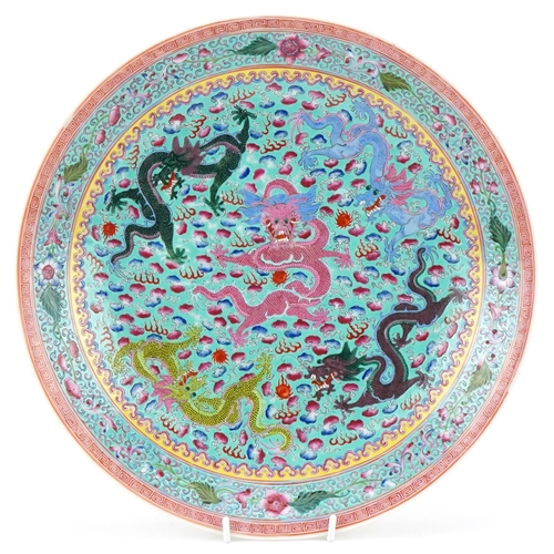 421 - A Chinese porcelain charger hand painted with dragons amongst clouds within a floral border, 34 cm i... 