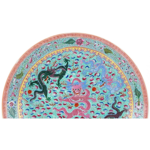 421 - A Chinese porcelain charger hand painted with dragons amongst clouds within a floral border, 34 cm i... 