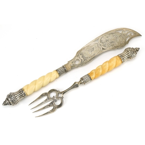 572 - A pair of mid Victorian silver fish servers, each with engraved decoration with reeded and foliate d... 