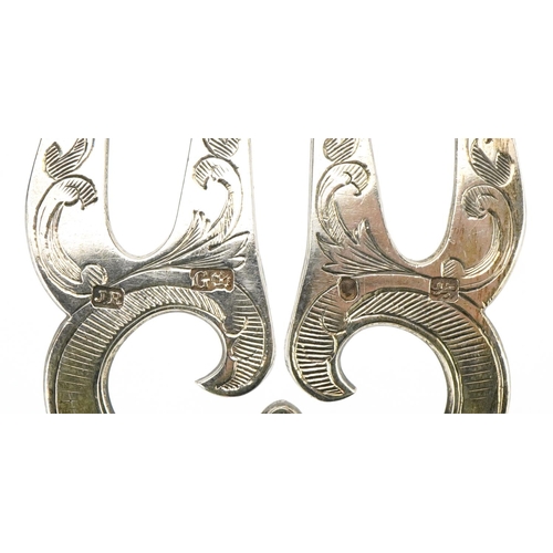 572 - A pair of mid Victorian silver fish servers, each with engraved decoration with reeded and foliate d... 