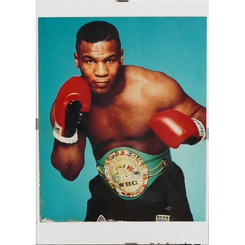 2306 - A small collection of sporting memorabilia relating to Mike Tyson including a colour advertising pos... 