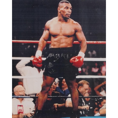 2306 - A small collection of sporting memorabilia relating to Mike Tyson including a colour advertising pos... 