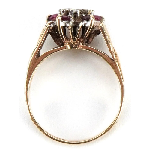 3477 - A 9ct gold diamond and ruby flower head ring with engine turned shoulders, size L, 3.3g, housed in a... 