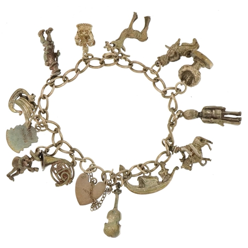 3483 - A silver charm bracelet with a collection of mostly silver charms including a Viking longboat, Frenc... 