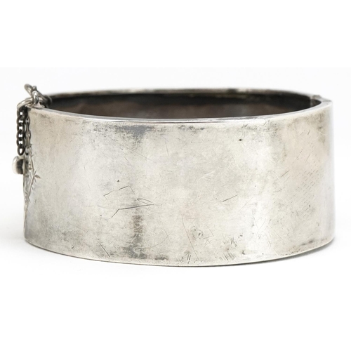 3445 - A Victorian silver belt buckle design hinged bangle with engraved foliate decoration, indistinct hal... 