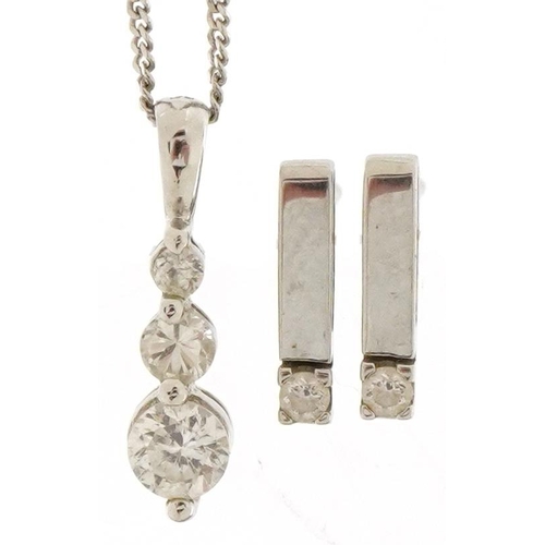 3509 - A 9ct white gold clear stone pendant on a 9ct white gold necklace and similar earrings, the necklace... 