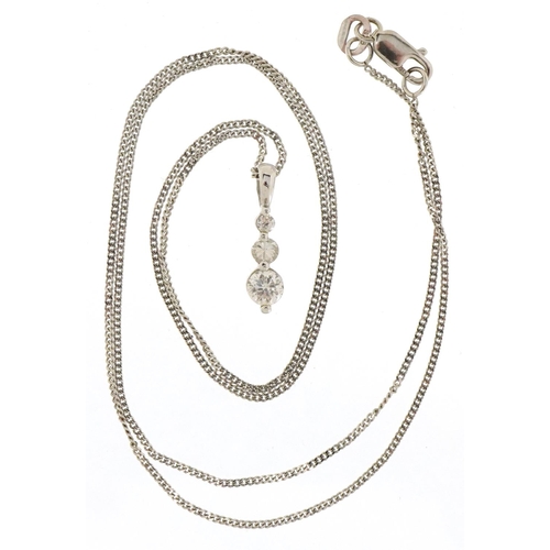 3509 - A 9ct white gold clear stone pendant on a 9ct white gold necklace and similar earrings, the necklace... 