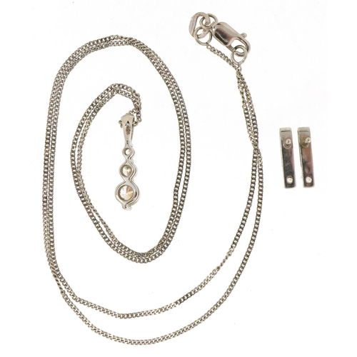 3509 - A 9ct white gold clear stone pendant on a 9ct white gold necklace and similar earrings, the necklace... 