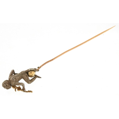 3146 - An antique unmarked gold, silver and yellow metal stickpin in the form of a monkey playing a violin,... 