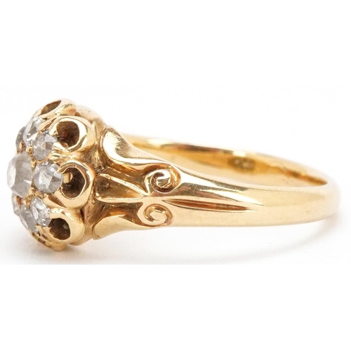 3012 - An unmarked 18ct gold diamond cluster ring with ornate setting, the central diamond approximately 3.... 