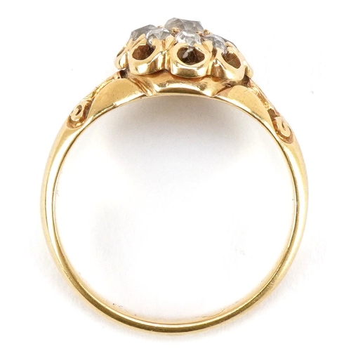 3012 - An unmarked 18ct gold diamond cluster ring with ornate setting, the central diamond approximately 3.... 